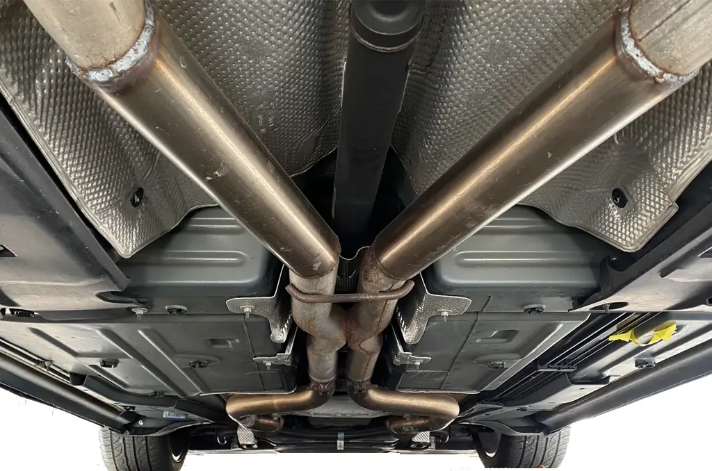 A mid muffler delete viewed from underneath a dodge charger. This specific kit also fits a dodge challenger.