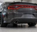 Rear of a dark grey Dodge Charger Scat Pack with the factory exhaust tips in the lower valance